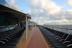 On the upper deck of a large ocean liner. photo