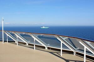 On the upper deck of a large ocean liner. photo