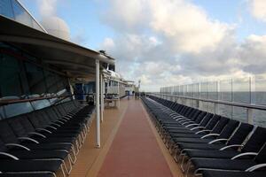 On the upper deck of a large ocean liner. photo