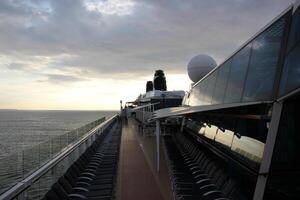 On the upper deck of a large ocean liner. photo