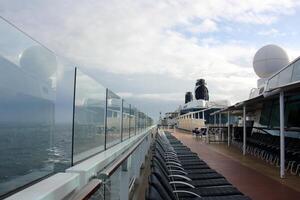 On the upper deck of a large ocean liner. photo