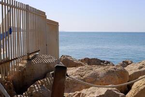 Stones and shells on the shore of the Mediterranean Sea. photo