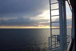 On the upper deck of a large ocean liner. photo