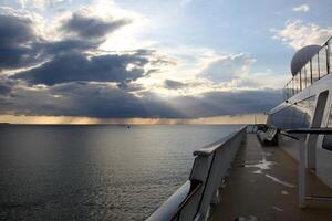 On the upper deck of a large ocean liner. photo