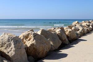 Stones and shells on the shore of the Mediterranean Sea. photo