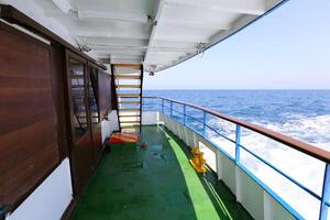 On the upper deck of a large ocean liner. photo