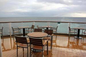 On the upper deck of a large ocean liner. photo