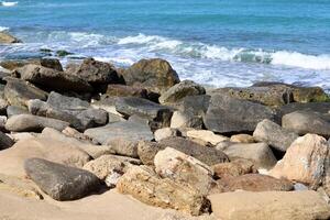 Stones and shells on the shore of the Mediterranean Sea. photo