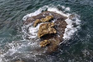 Stones and shells on the shore of the Mediterranean Sea. photo