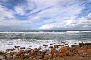 Stones and shells on the shore of the Mediterranean Sea. photo