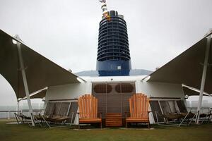 On the upper deck of a large ocean liner. photo