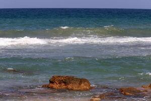 Stones and shells on the shore of the Mediterranean Sea. photo