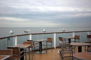 On the upper deck of a large ocean liner. photo