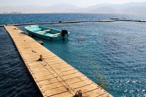 A pier on the shore for mooring boats and yachts. photo