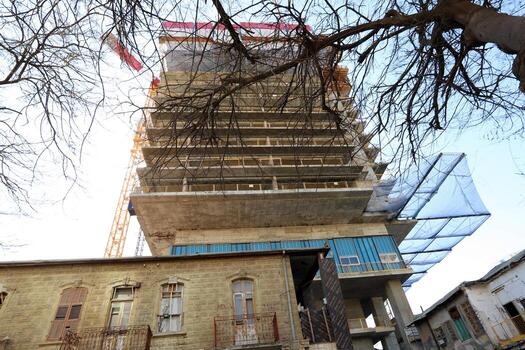 Tel Aviv Israel 03 28 2024. Buildings and structures in Tel Aviv through the foliage of tall trees. photo
