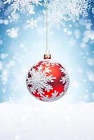 Christmas bauble on a snowy winter background, Merry Christmas and Happy Holidays wishes, photo