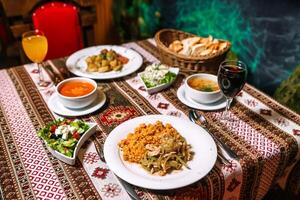 Table With Food Plates and Soup Bowls photo