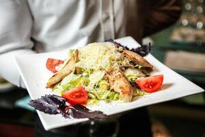 Person Holding Plate With Salad photo