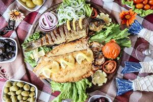 Plate of Food With Fish, Olives, Tomatoes, Lettuce photo