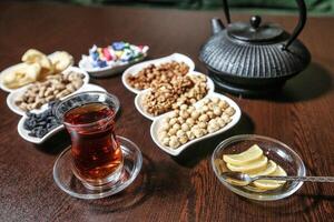 Wooden Table With Bowls of Food and Cup of Tea photo