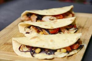 Wooden Cutting Board With Three Tortillas photo