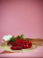 Bouquet of Roses Wrapped in Brown Paper photo