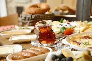 Wooden Table Adorned With Food Plates and Cup of Tea photo