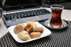 Assorted Pastries and Glass of Tea on a Plate photo