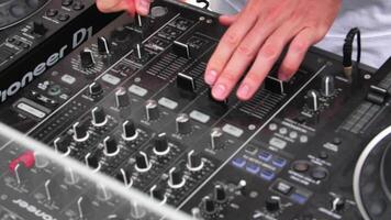 Hands of DJ on mixing console. Slow motion video