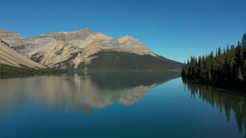 Aerial view of Bow Lake and the reflection of Mount Jimmy Simpson video