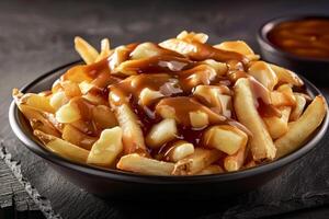 French fries with barbecue sauce. Black matte plate, black background. Macro photo