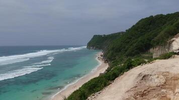 Surf on the ocean coast of Bali, Indonesia. Drone video