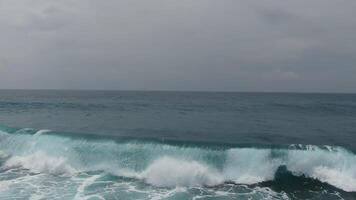 Surf on the ocean coast of Bali, Indonesia. Drone video