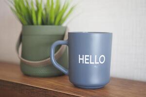 blue coffee cup with hello word photo