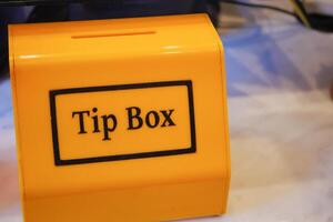 close up of a tips box in a cafe photo
