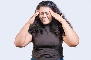Young woman with headache isolated. Girl suffering from migraine holding head. Headache concept photo