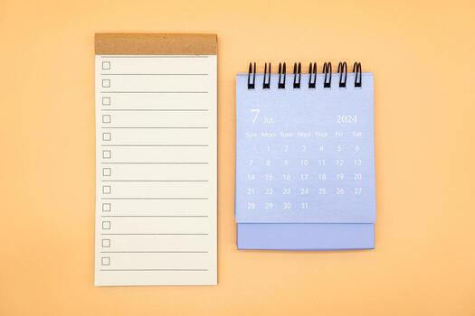 Blank to do list for text with checkbox and Simple desk calendar on JULY 2024. Empty Check list. Copy Space. isolated background. To do list in July 2024. photo