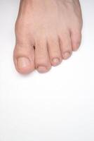 Close up of a person left foot toes with white background and space below for text photo