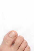 Closeup of a toe with white background and space above for text photo