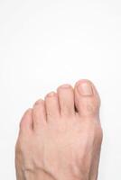 Close up of a person left foot toes with white background and space above for text photo