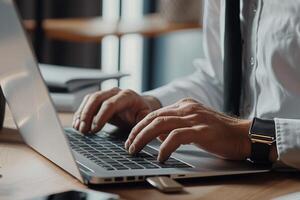 Business professional in formal dress working on a laptop in modern office photo