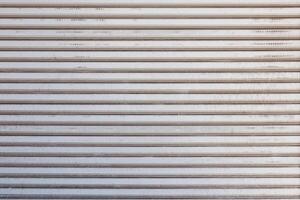 Closeup of a weathered metal shutter with horizontal folding lines photo