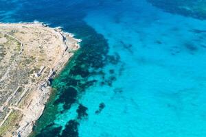 Aerial drone photo - The famous Blue Lagoon in the Mediterranean Sea. Comino Island, Malta.