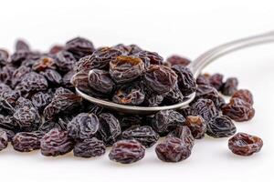 Raisins on Spoon Isolated on White Background photo