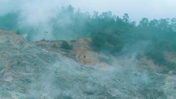 nebbioso montagna paesaggio con Fumo crescente a partire dal foreste piste, la creazione di un' misterioso atmosfera. video