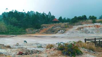 Scenic view of a tranquil quarry with lush greenery in the background under a hazy sky. video