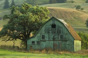 Vintage rustic barn in grassy field photo