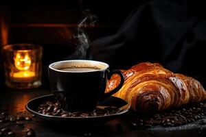 Steaming black coffee in a ceramic mug and a flaky croissant on a dark wooden surface with coffee beans and warm candlelight photo