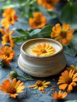 Calendula cream and calendula flowers photo