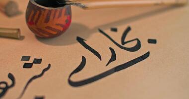 Instruments of the Arabic caligraph on the table next to the letter. video